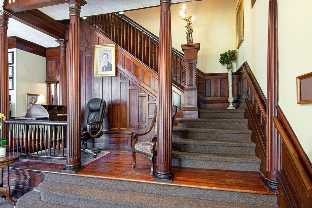 The wooden staircase and foyer inside Evangeline Funeral Home