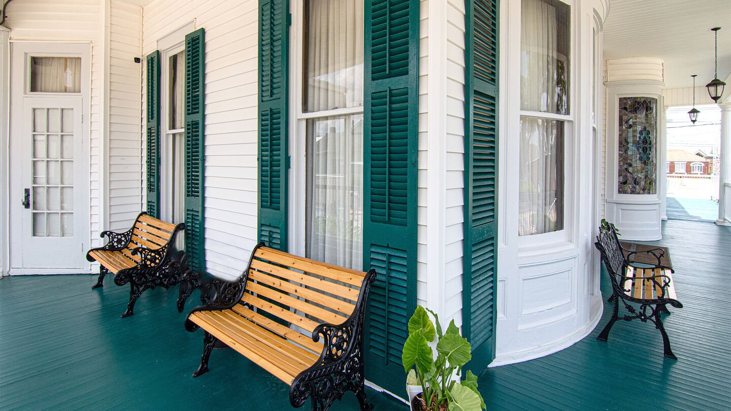 The shaded front porch of Evangeline Funeral Home